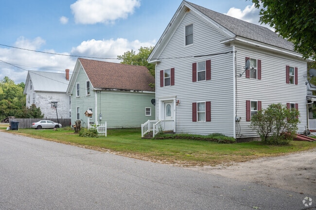 A row of New England-style homes lines a quiet street in Mattawamkeag.