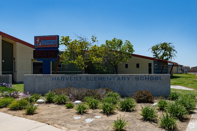 The sign welcomes students and staff as they enter Harvest Elementary.