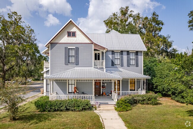 A beautiful blue two story historic Victorian style home in SE Ocala.