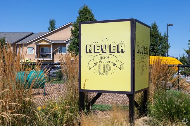 Encouraging 'Never Give Up' signs can be found throughout Landover-Sharmel neighborhood.