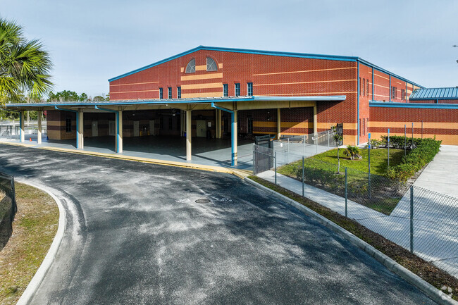 Camelot Elementary School features a large awning for shelter during bus loading.