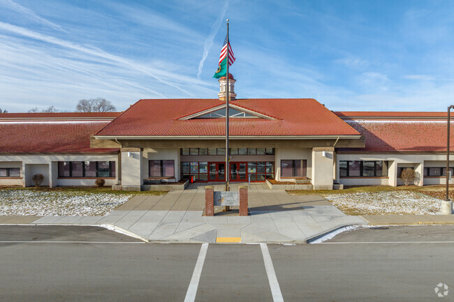 The Otis Orchard School features a long single store building.