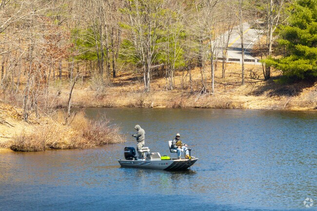 Fishermen perch on their boat while hoping for a big catch on Mansfield Hollow Lake in Chaplin.