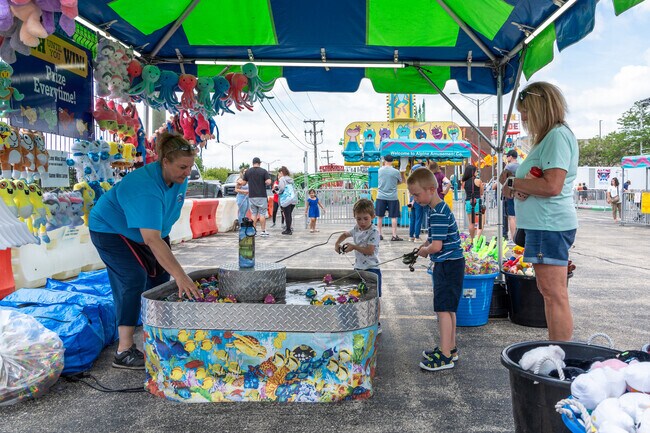 Kids play the fishing game at the Roselle Lions Rose Festival.