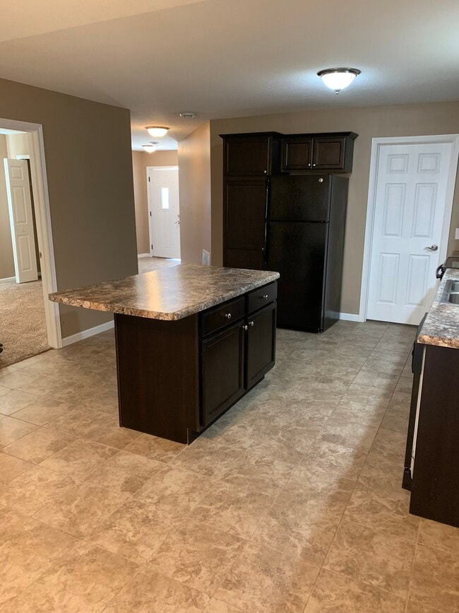 Easy kitchen access from attached two-car garage (white solid door), or front door (white door with window)