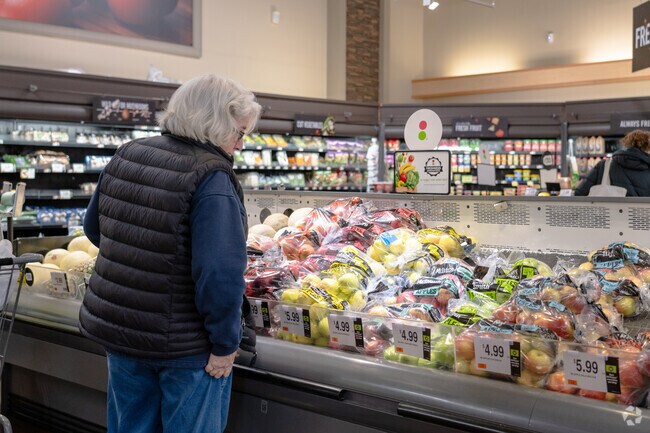 A woman shops for apples at the Shaw's in Wayland Town Center.