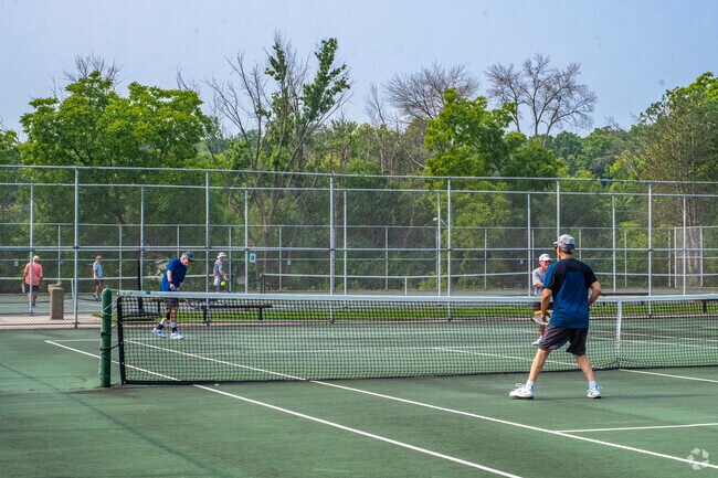 Residents of South Madison enjoy weekends at Quann Park's tennis courts.