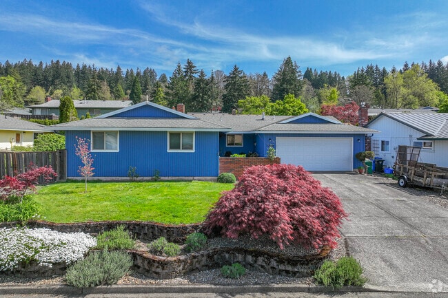 Vibrant blue Rancher home with well-manicured landscaping in the Jennings Lodge neighborhood.