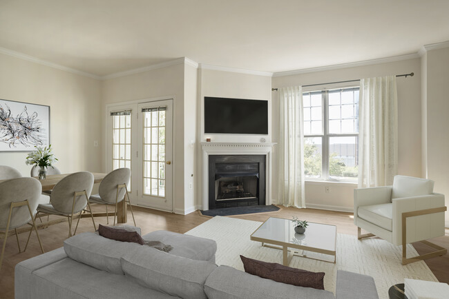 Renovated Package II living and dining area with fireplace and hard surface flooring