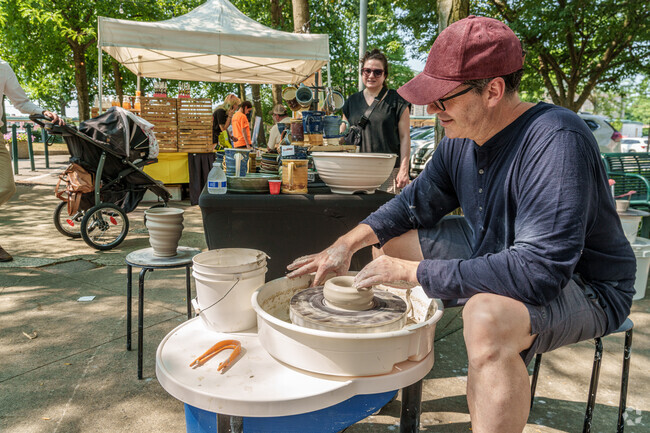 A potter demonstrates his skill for visitors to his tent at the Pottstown Farmers Market.