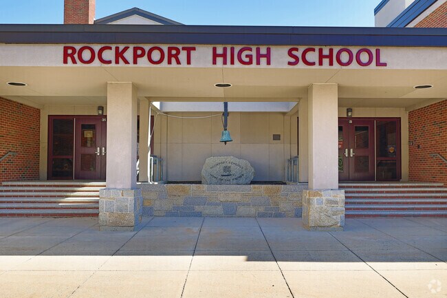 Rockport High School displays a large bell outside its door.
