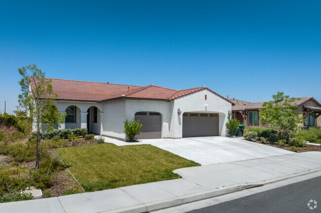 Spanish style home with a beautiful green lawn seen in West Redlands.