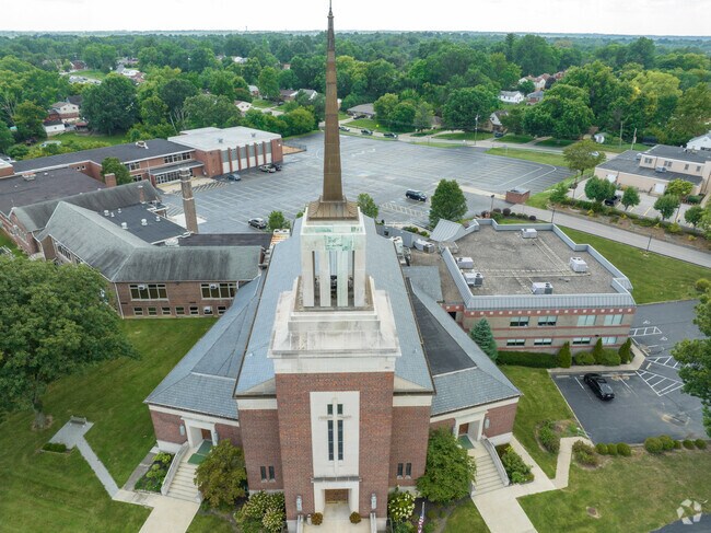 Front of church with school in distance.