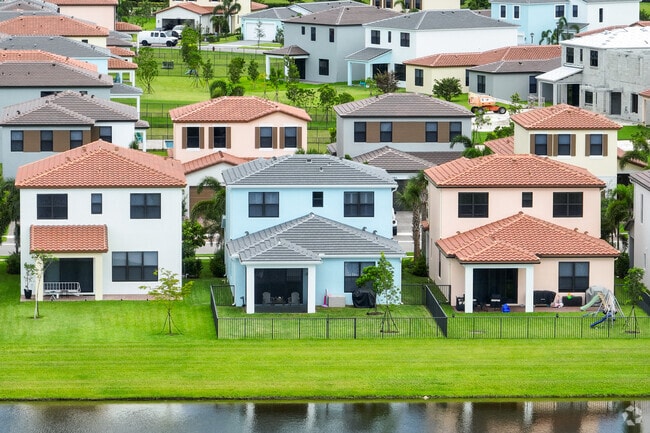 New homes are for sale by the lake in the Loxahatchee Groves neighborhood.