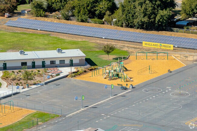 A blacktop area with basketball hoops and a large playground are available for kids to play on at Murdock Elementary School.