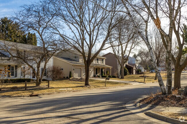 Traditional homes sit alongside mature trees in Wexford Village.