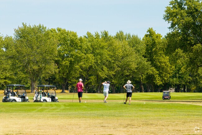 Golfers enjoy sunny rounds at Whispering Oaks Golf Course.