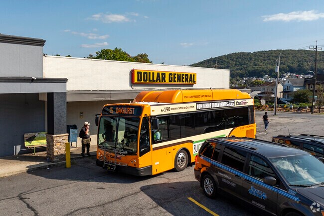 A CamTram buses picks up shoppers in front of the Dollar Tree in Oakhurst.