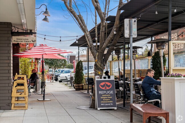 Patrons relish alfresco dining at a cozy street-side eatery near Clearfield Park.