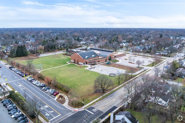 Greenbriar School has large open spaces and a playground adjacent to the school building.