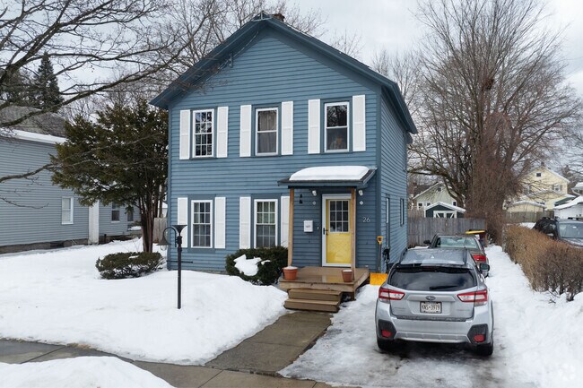 A classic Colonial home pops out in the mute winter with an inviting yellow door.