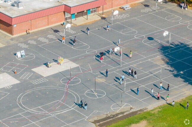 Students at David Reese Elementary plays basketball and volleyball during recess.