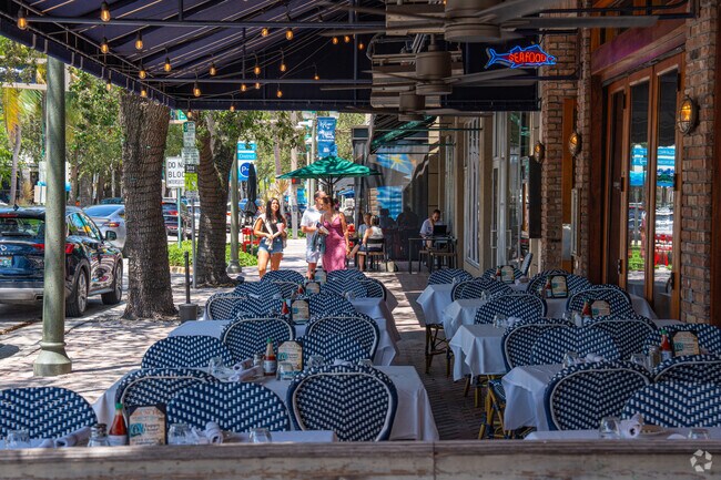 Open‑air patios line the entertainment district off Atlantic Avenue.