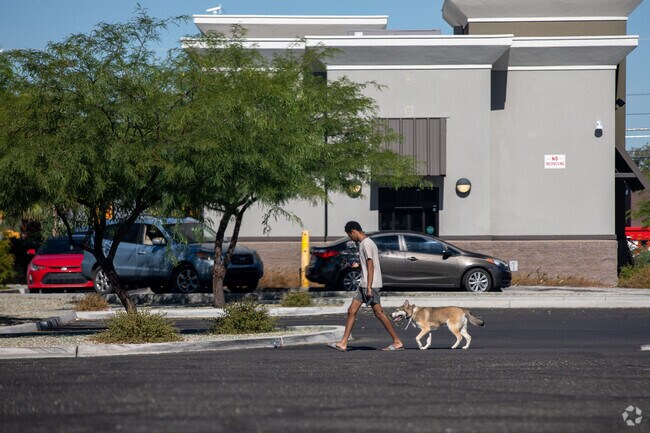 A Limberlost resident walks his dog by Starbucks on First Avenue.