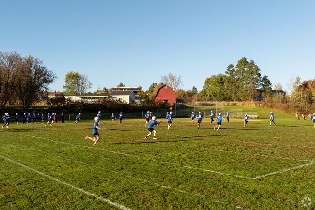 Football players run through practice drills at Fairfax Community Park in Fairfax Village.