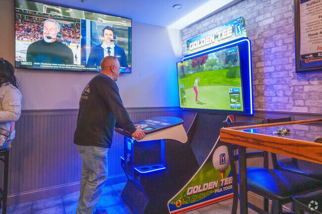 Play a game of Golden Tee inside Main ST Grille & Taphouse while you have a drink or wait for your food near Montrose.