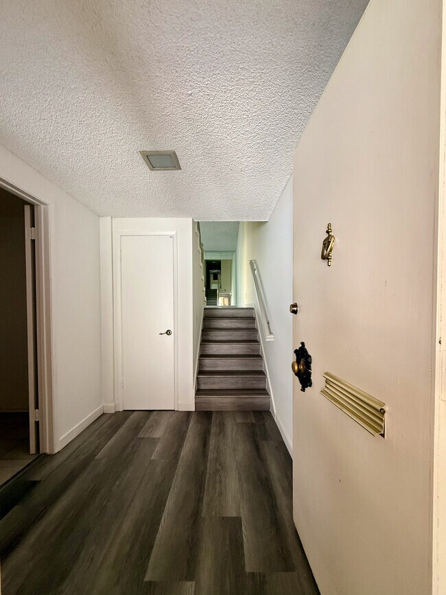 Entrance with coat closet and laundry room