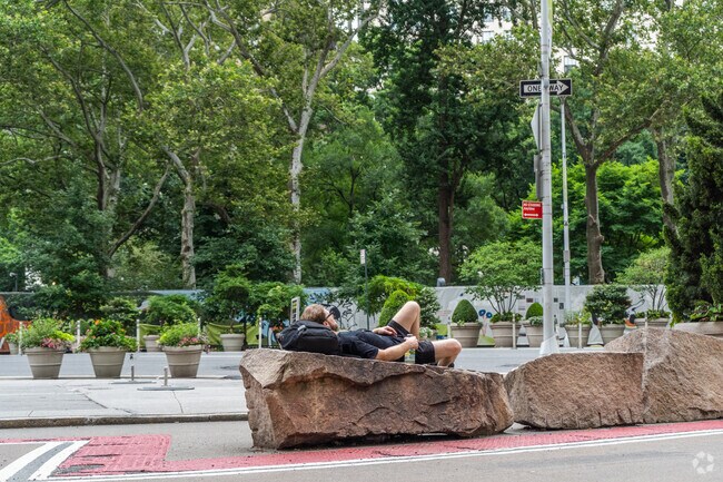 Visitors relax near Madison Square Park