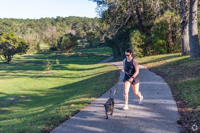 Dog owners and their furry companions enjoy a stroll through Daphne Central Park.