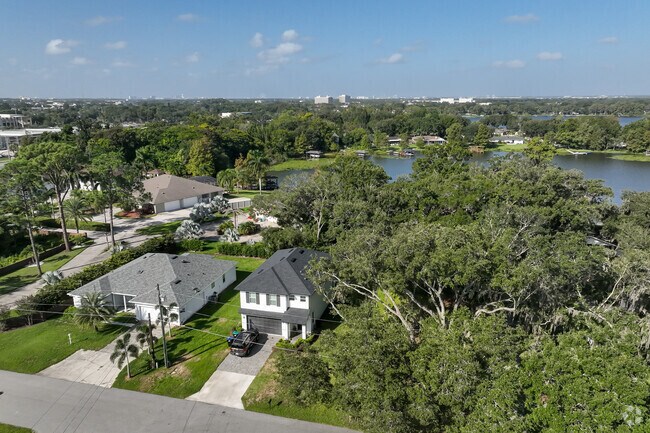 An adorable, aerial view of modern style properties residing on Lake Jasmine.