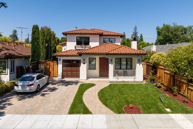 Elegant wooden doors bring warmth and character to this Spanish-style residence.