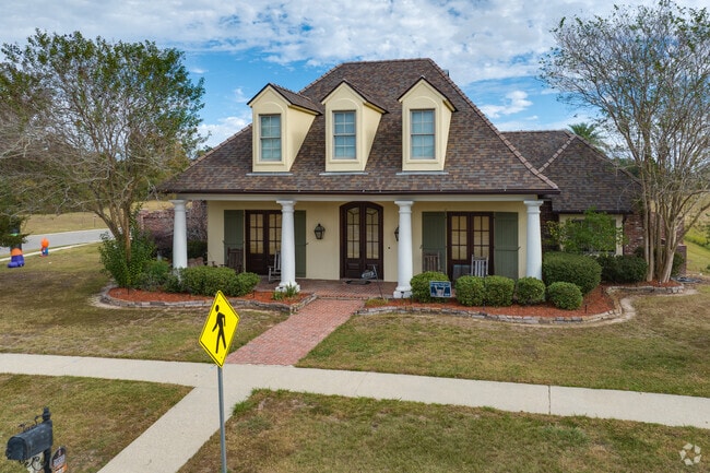 Newly built French country-style homes line the peaceful streets of Acadiana Wood.