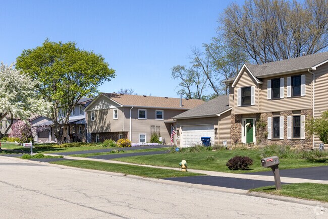Split-level homes sit beneath blooming trees in the quiet neighborhood of The Links of Midlane.