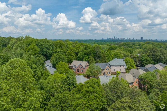 Underwood Hills offers a peaceful enclave of charming brick homes nestled within a dense canopy of trees.