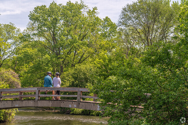 A Naperville couple rest & take in the natural beauty of Hobson Village's Pioneer Park.