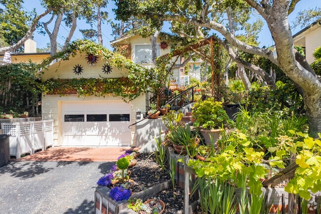 Cottages with sprawling flowering vines adorn Carmel-By-The-Sea, California.