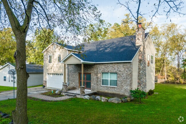 A stone farmhouse is a unique addition to the neighborhood of Third Lake.