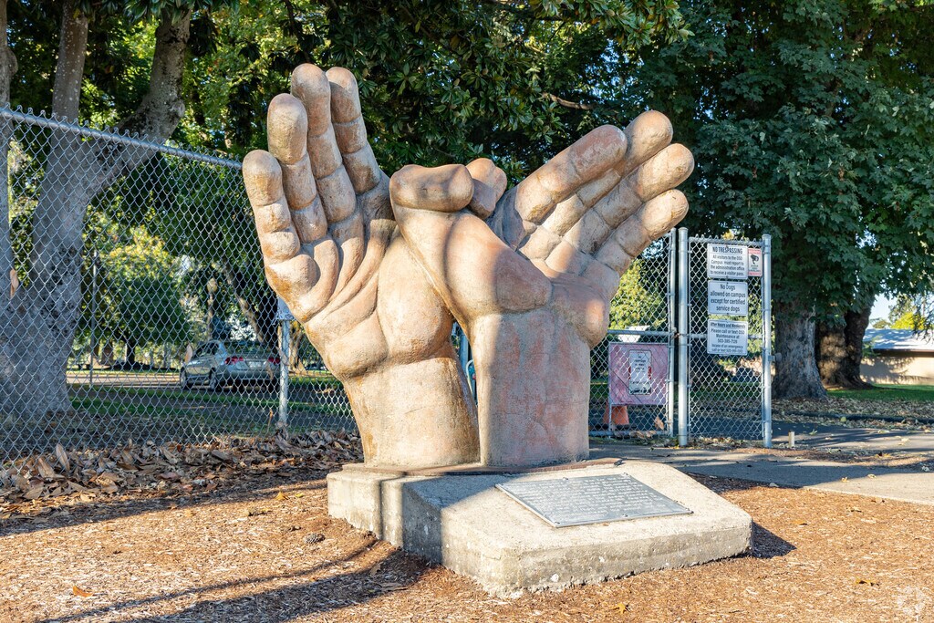A statue of the Butterfly hand shape is set facing the Highland neighborhood.