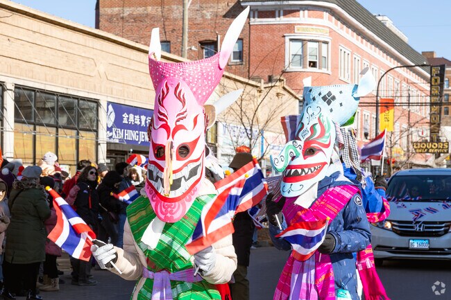 Celebrating SE Asian diversity during Lunar New Year, Thai students display mask's and flags.