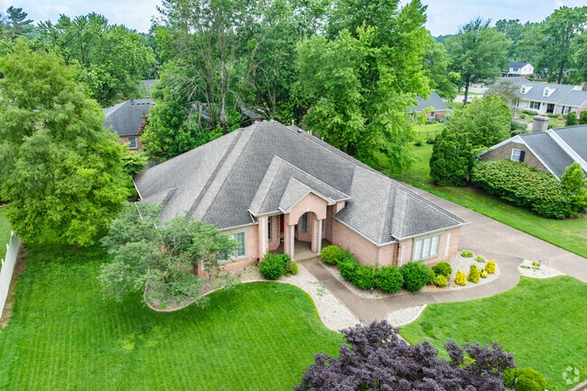 In Plaza Park there are large oak trees growing on manicured lawns.