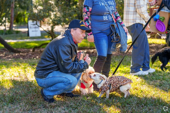A Winter Park resident enjoys letting his dog meet others at Dog Day in Leu Gardens.