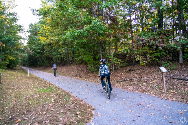 A couple riding the bicycles turns onto the Nashua Rail Trail in Southwest Nashua.