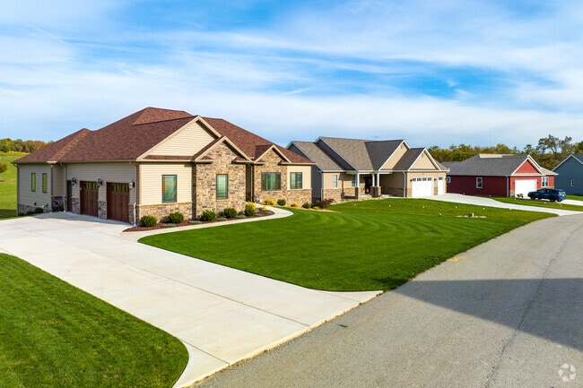 New homes in Menallen Township feature manicured lawns and modern designs priced around $300K.