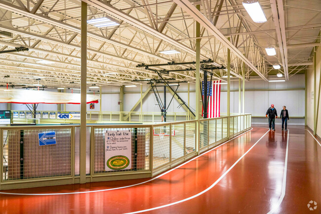 People walk along the indoor track at Claremont Community Center near South End.