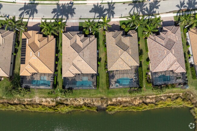 Lakefront homes line the shores at The Preserve At Corkscrew,  each with their own private pool.