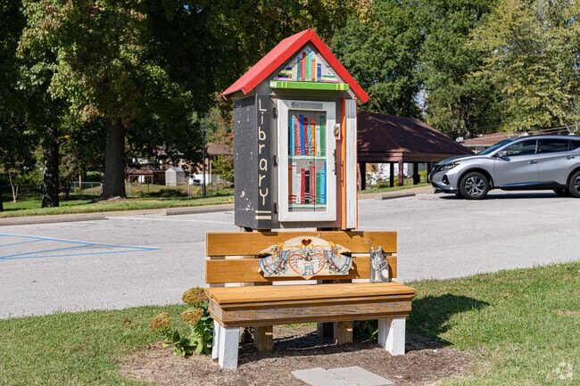 Take a seat and enjoy a new book from the Little Free Library in Saint John Park.